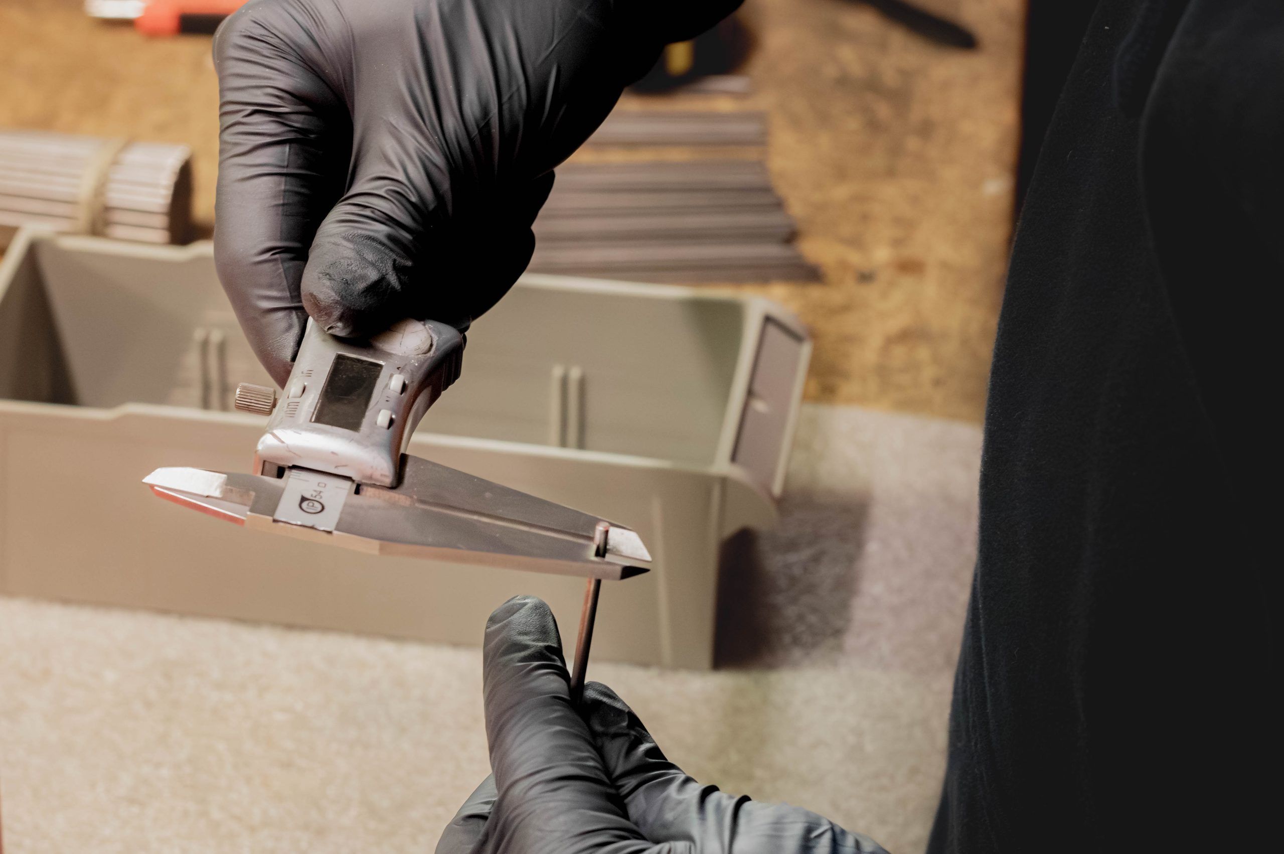 Precision caliper measuring a machined part